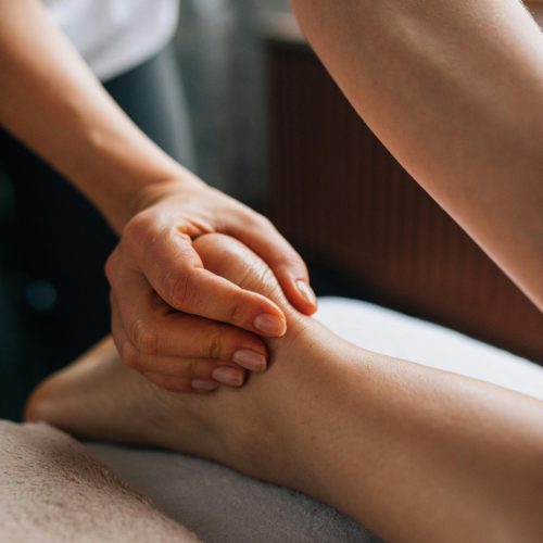 Soothing foot massage in a calm indoor setting, promoting relaxation and self-care.